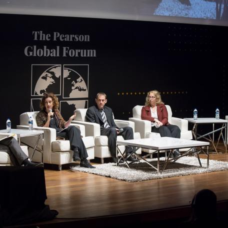 Panelists on stage discussing using data to address conflict at the Pearson Global Forum 
