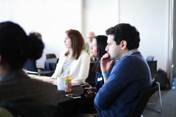 Several Pearson Fellows and Harris Public Policy students staring in concentration during The Darker Side of Peace Agreements conference, held by The Pearson Institute in May 2019. 